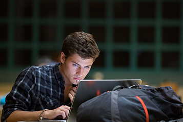A student works on their laptop.